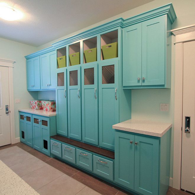 an empty kitchen with blue cabinets and white counter tops in the center, along with drawers on both sides