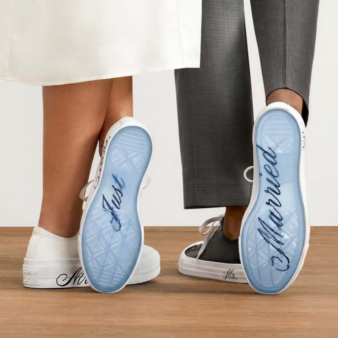 two people standing next to each other wearing blue shoes