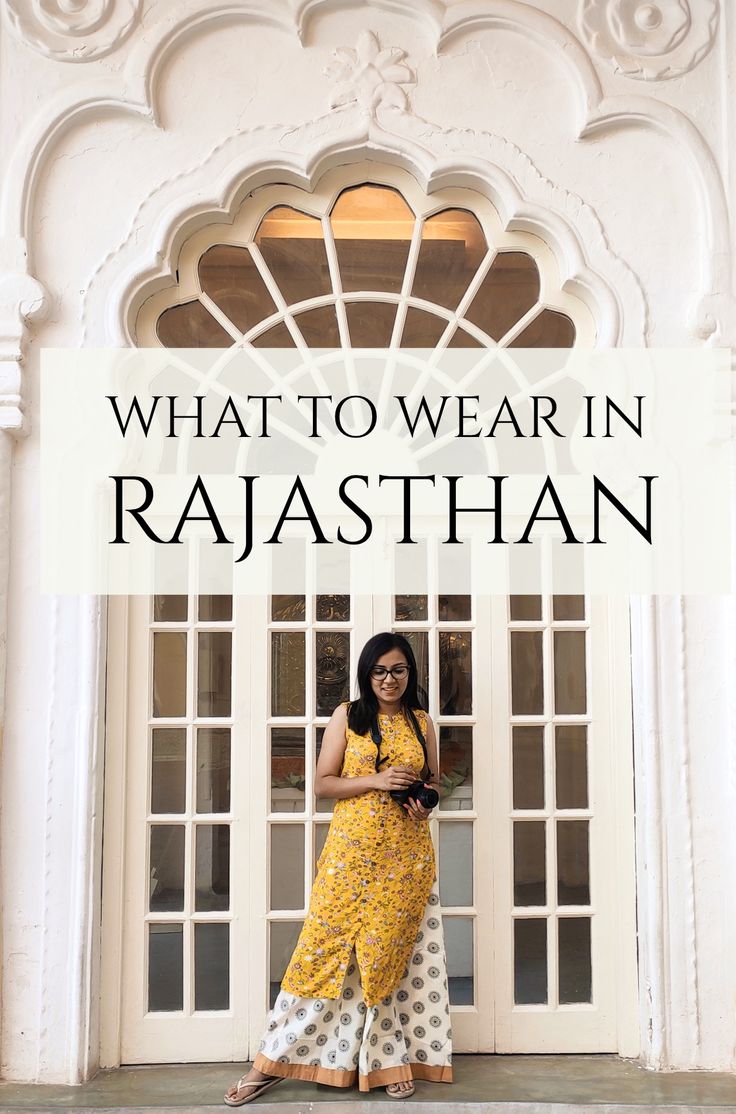 a woman standing in front of a white building with the words what to wear in rajasthan