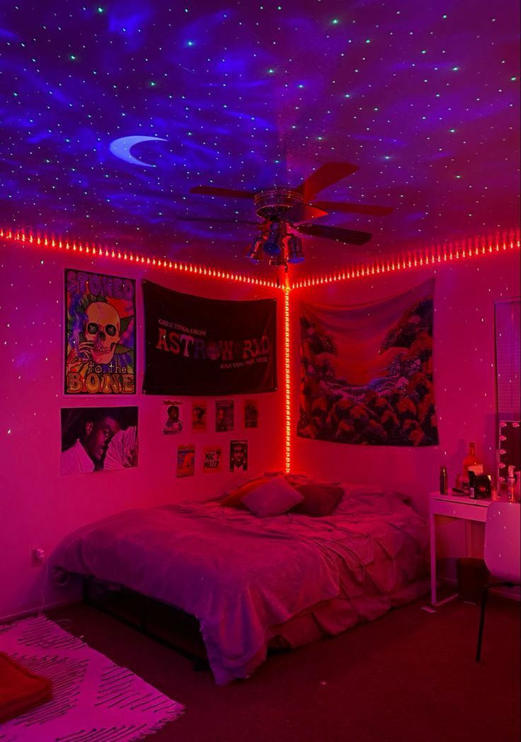 a bedroom with pink walls and stars on the ceiling is lit up by purple lights