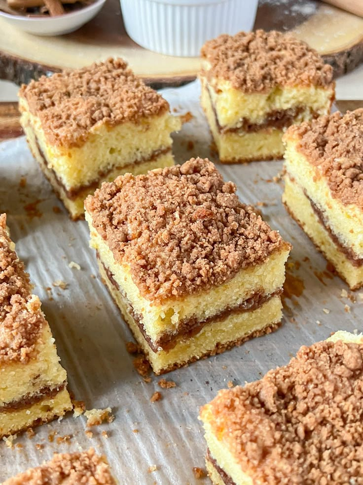 several pieces of cake sitting on top of a baking sheet with crumbs all over it