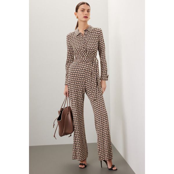 Brown geometric jersey (87% Viscose, 10% Nylon, 3%Spandex). Jumpsuit. Long sleeves. Collar. Front button closure. 58" from shoulder to hemline. Imported. Chic Long Sleeve Jumpsuits In Elastane, Chic Long Sleeve Jumpsuits And Rompers For Office, Fitted Elastane Jumpsuits For Work, Fitted Office Jumpsuits And Rompers For Fall, Fitted Elastane Jumpsuits And Rompers For Work, Fitted Jumpsuits And Rompers For Office In Fall, Fitted Fall Jumpsuits And Rompers For Office, Printed Long Sleeve Jumpsuit For Fall, Printed Long Sleeve Jumpsuits And Rompers For Fall