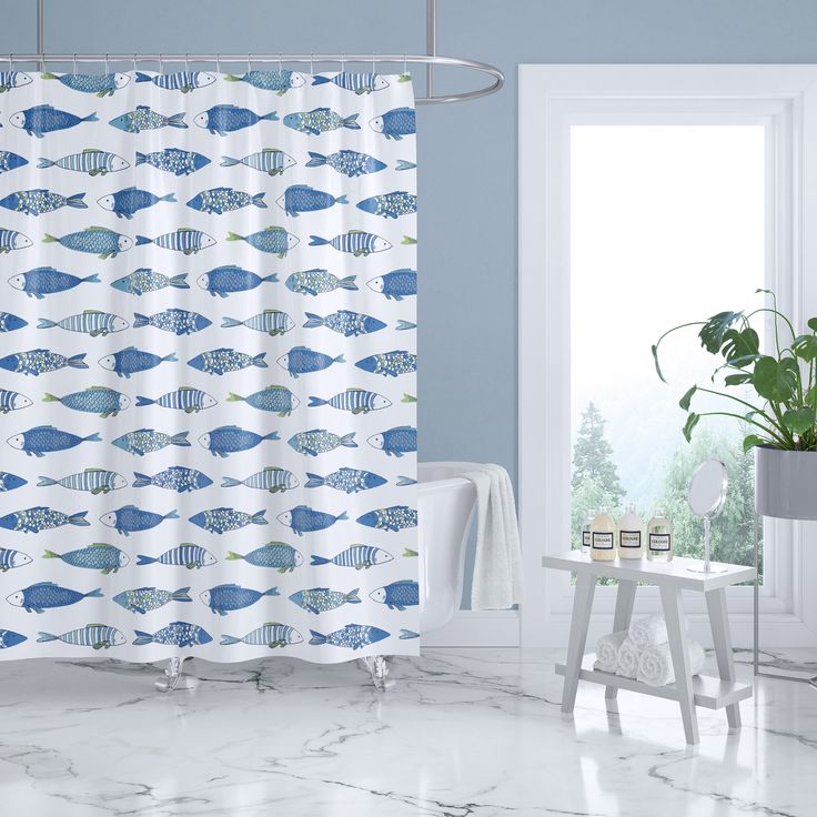 a shower curtain with blue fish on it