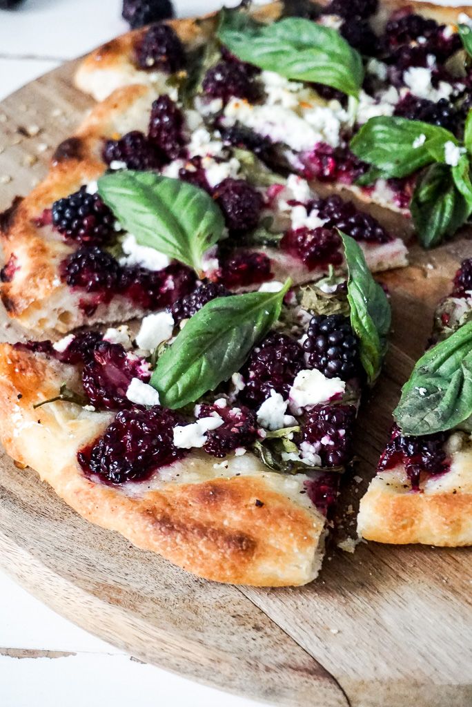 a close up of a pizza on a cutting board