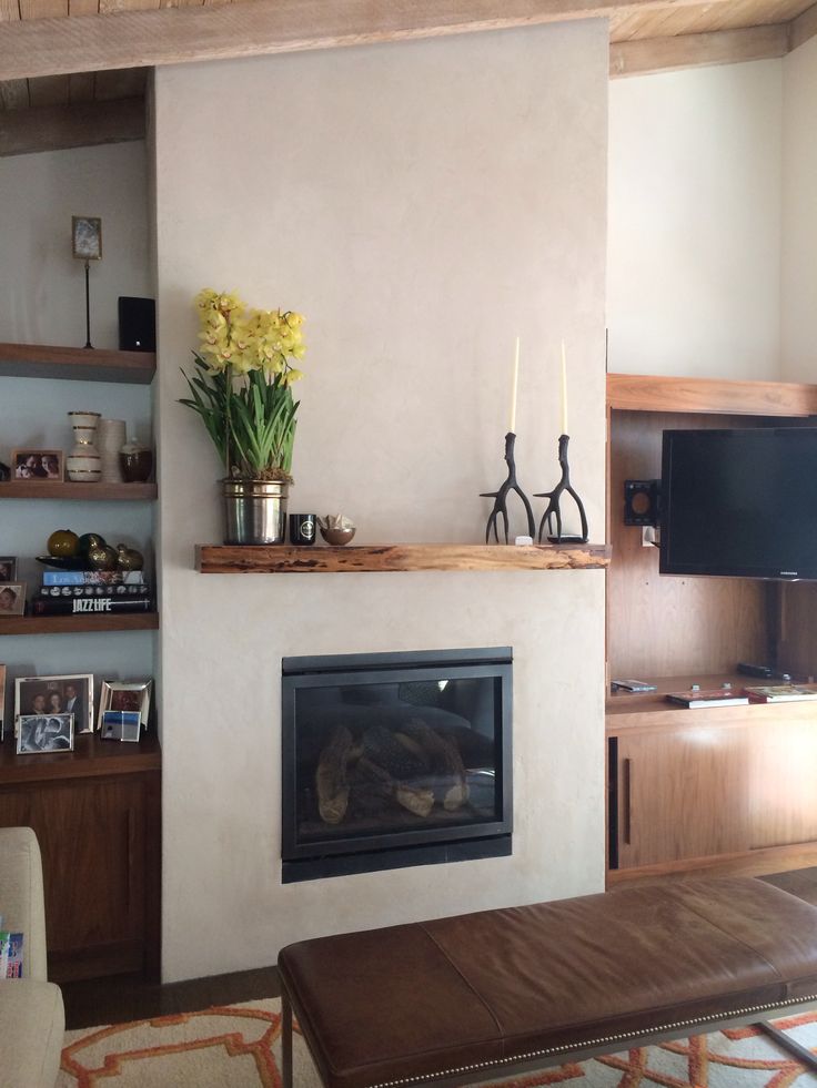 a living room filled with furniture and a fire place in front of a flat screen tv