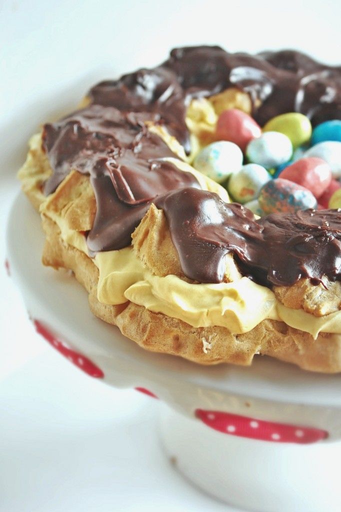 a cake with chocolate frosting and candy on top is sitting on a white plate