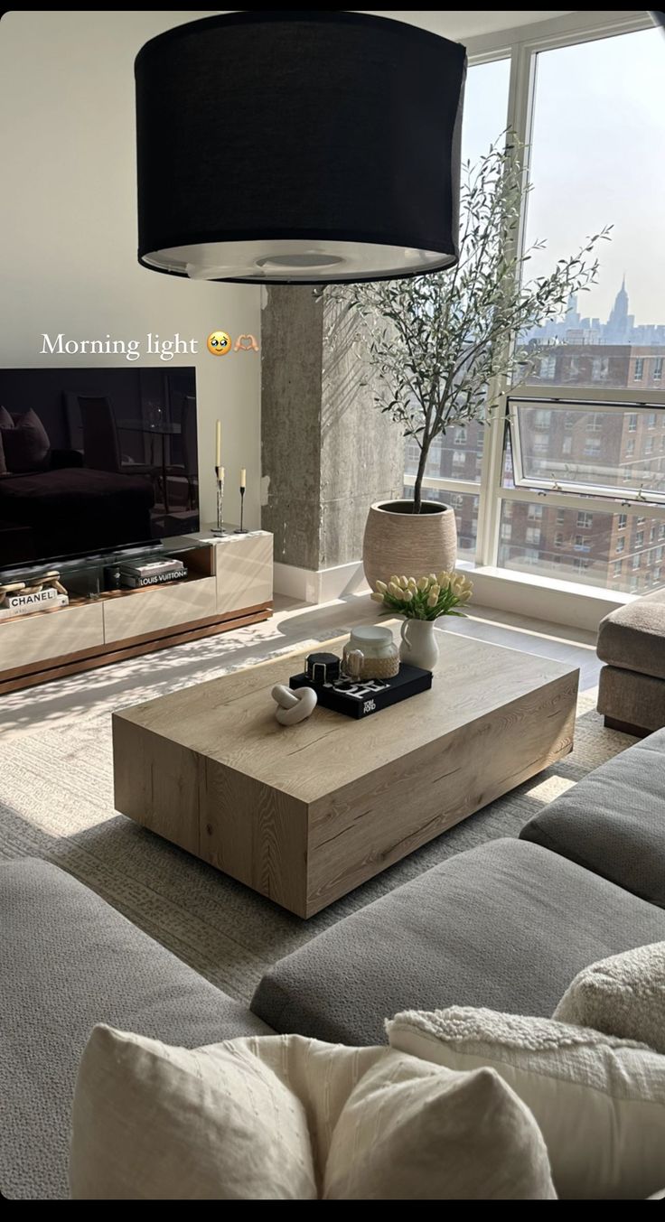 a living room filled with furniture and a flat screen tv on top of a wooden table