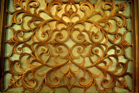 an intricately carved wooden wall panel