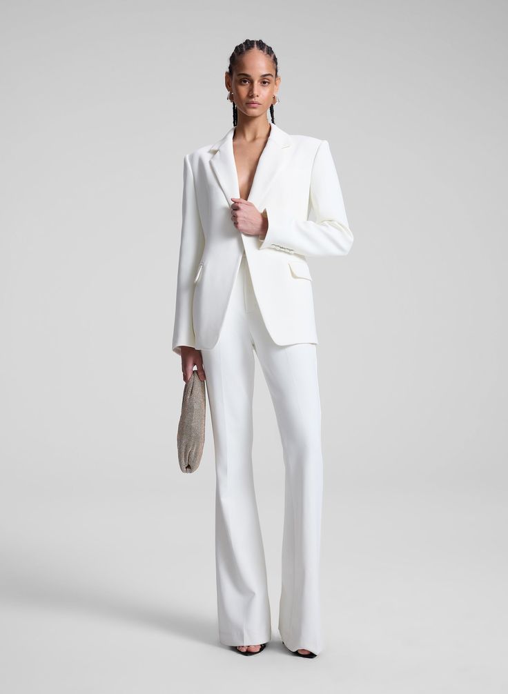 The Sophie II Pant is crafted from our signature suiting fabric in a timeless shade of off white. This flared-leg silhouette features a mid-rise waist and slash pockets. Shop Bottoms Styling Tip: Pair with the Elza Blazer and pointed-toe pumps for an iconic, tailored look. Off White 4, Suiting Fabric, Tailored Pants, Tailored Jacket, Modern Woman, Dress Pants, Mid Rise, Ready To Wear, Pumps