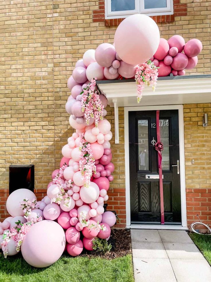 balloons and streamers decorate the front of a house