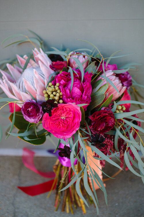 a bridal bouquet with pink and purple flowers