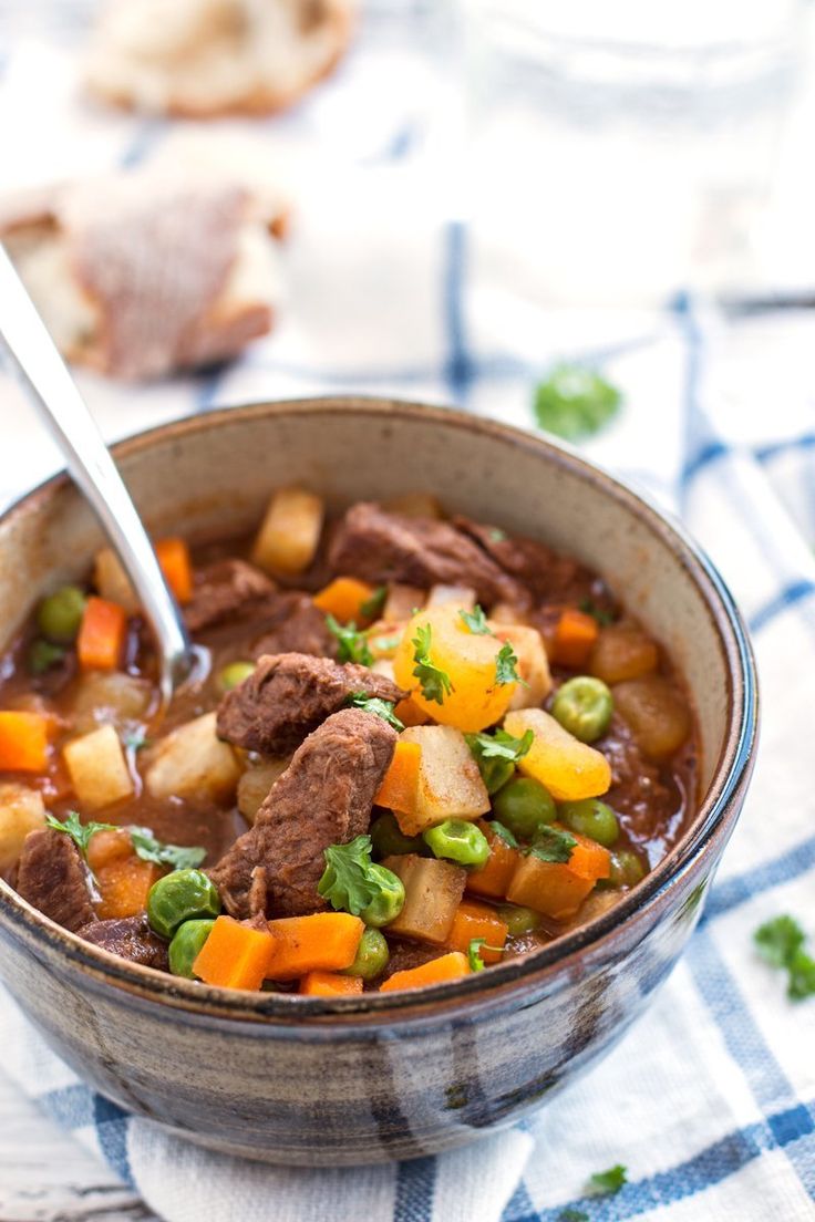 a bowl of beef stew with carrots and potatoes