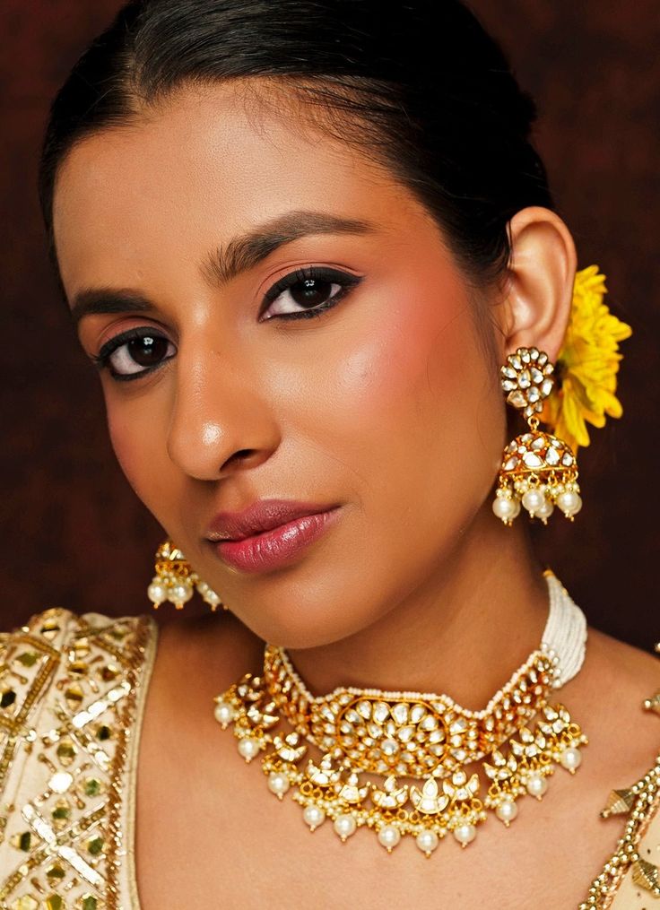 Elevate your festive wardrobe with the exquisite Gold Finish Kundan Choker Set, masterfully crafted from mixed metal and adorned with radiant Kundan and Pearl stones. The choker, beautifully strung with delicate pearl lines, exudes a regal charm, while the matching jhumka earrings add a touch of traditional elegance. Finished with a rich 22kt gold plating, this set is perfect for weddings, parties, and other Indian festivities, offering a harmonious blend of timeless tradition and modern sophist Festive Pearl Choker Necklace For Celebration, Festive Pearl Choker For Celebration, Intricate Design Kundan Choker Necklace For Celebration, Kundan Choker Necklace With Intricate Design For Celebration, Bollywood Style Pearl Necklace For Diwali Ceremonies, Heavy Pearl Necklace For Festive Occasions, Intricate Design Choker For Diwali Celebration, Ceremonial Jewelry With Gota Work For Eid, Festive Chandbali Choker