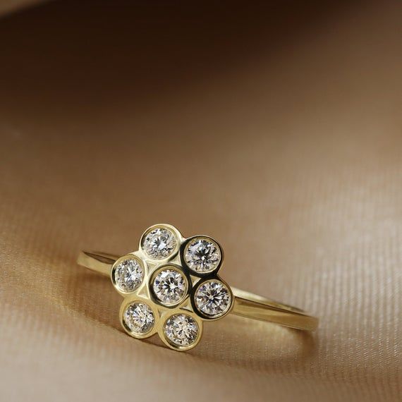 a gold ring with three diamonds on it