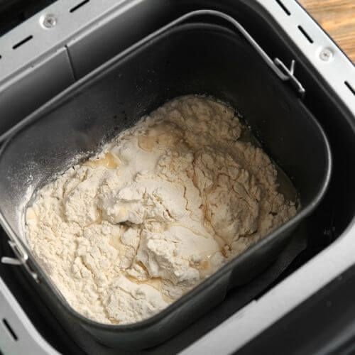 a pan filled with flour sitting on top of a wooden table