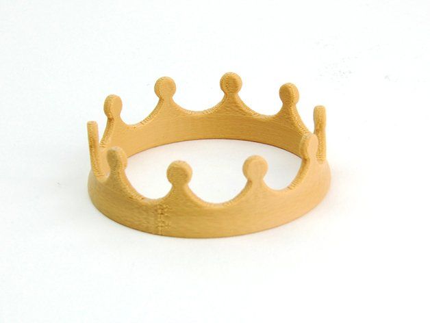 a wooden ring with a crown on it's side, against a white background