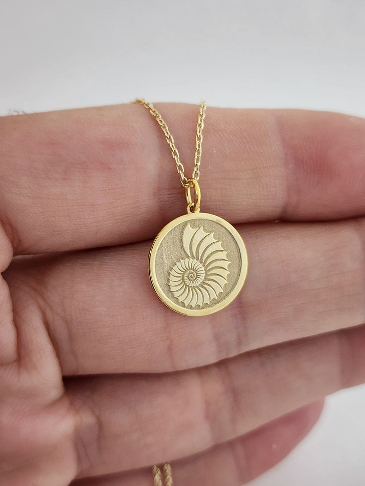 14k Gold Seashell Necklace , Personalized Seashell Pendant, Shell Charm Pendant ,Dainty Sea Shell Layered Necklace , Shell Jewelry ,Birthday 14 Material of pendant: Solid gold 14k ♣ Metal Stamp: 14k ♣The pendant is available in 3 sizes: 12.7 / 0,50 inches ( Diameter ) 15.2 mm / 0,60 inches ( Diameter ) 19,1 mm / 0,75 inches ( Diameter ) ( In the photos the size of the pendant is 15mm / 0.55 inches Diameter ) ♣ Material of chain: Solid gold 14k  Chain Length: ♥40 cm / 15,75 inches ( Length ) ♥45 cm / 17,72 inches ( Length ) ♥50 cm / 19,68 inches ( Length ) ♥ 55 cm / 21,65 inches ( Length ) Pendant thickness : 0.55mm Inner diameter of jump ring : 4mm Gold Shell Necklace Perfect As A Gift, Gold Shell Necklace For Gift, Gold Shell Necklace As A Gift, Gold Shell Necklace Gift, 14k Gold Shell Jewelry For Gifts, Gold Shell Necklace With Round Pendant As Gift, Shell-shaped Gold Jewelry For Anniversary, Yellow Gold Shell Necklace For Gift, Delicate Gold Shell Necklace As A Gift