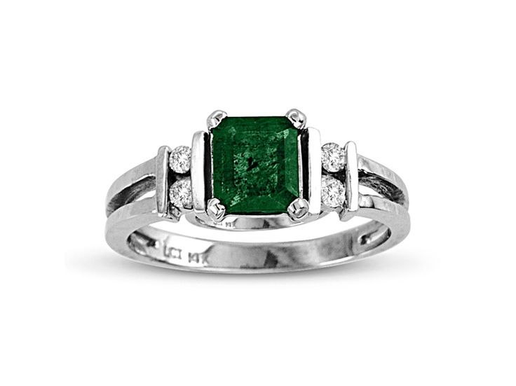 an emerald and diamond ring on a white background