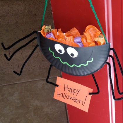 a halloween decoration hanging on the side of a red door