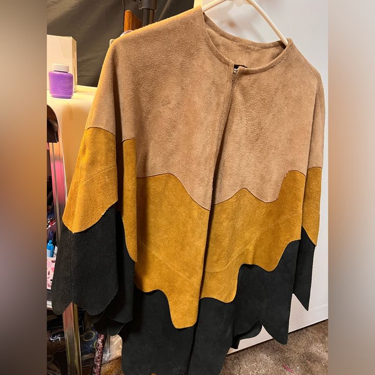 This Is A Beautiful Vintage Suede Leather Poncho. Handmade Purchased On A Navaho Reservation. It’s Larger As It Was Made For A Man, But Can Easily Be Worn By Anyone. Measurements Are: 48” Arm To Arm, 28” Shoulder To Shoulder, 31” Front Bottom To Top, 34” Back Bottom To Top, And 8” Neck Hole. Light Tan And Yellow With Black Scalloped Suede. It Zips All The Way Down Yo Open In The Front Like A Jacket. Zipper Works Great. Minimal Flaws As Seen In Pictures. I Would Say Size M/L Vintage Suede, Front Bottoms, Black And Tan, Suede Leather, Mens Jackets, Jackets & Coats, Man Shop, Yellow, Leather