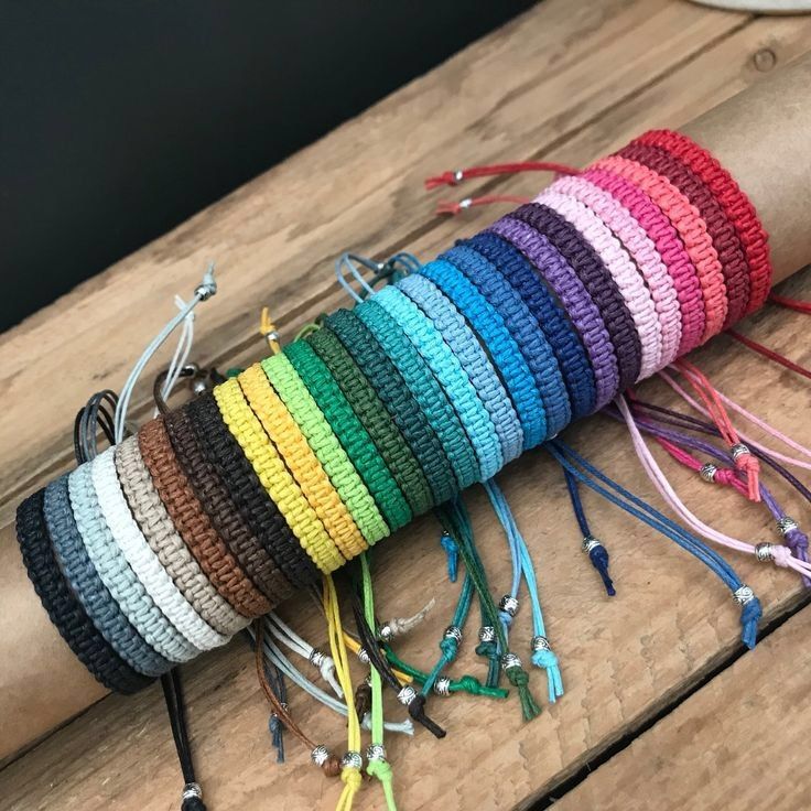 a group of bracelets sitting on top of a wooden table