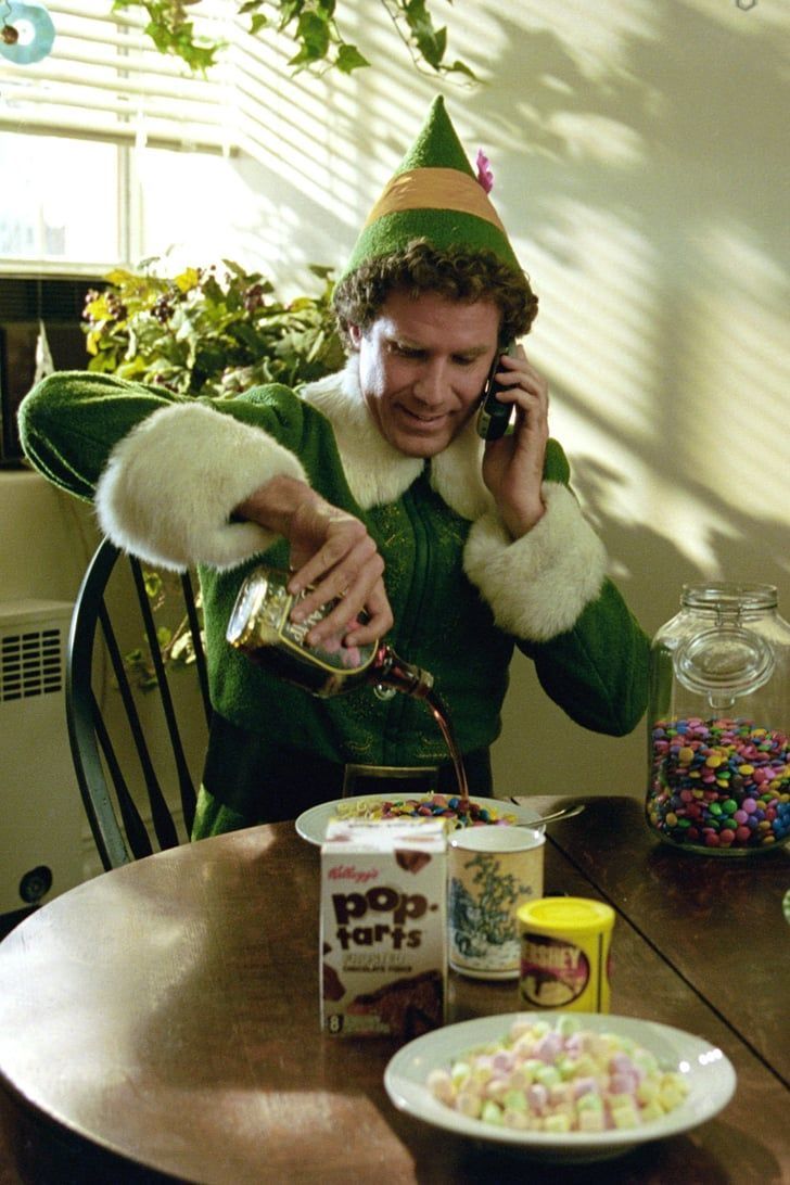 a man dressed as elf is talking on his cell phone while eating cereal and candy