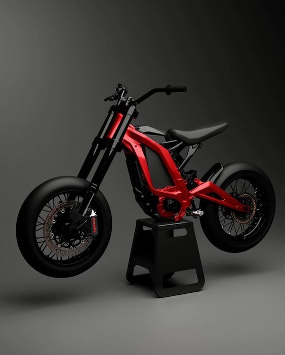 a red motorcycle sitting on top of a black stand in front of a gray background