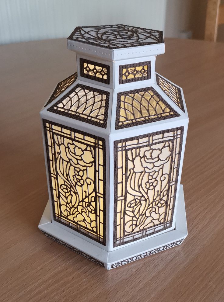 a decorative lantern sitting on top of a wooden table