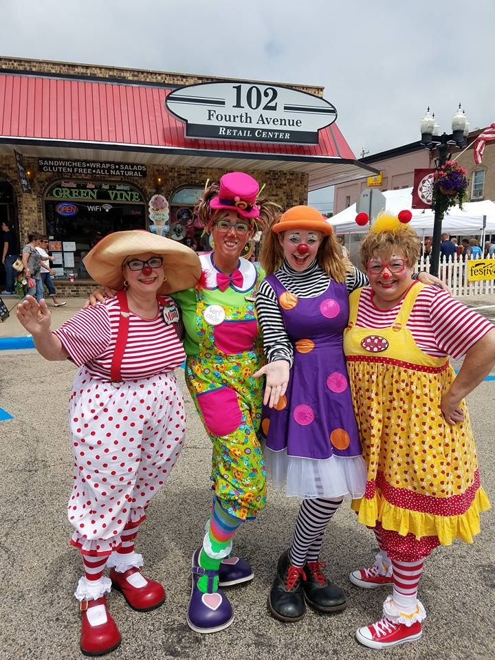 three women dressed in clown costumes posing for the camera