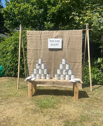 there is a sign that says tin can alley on the side of a wooden bench