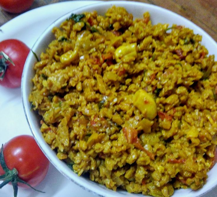 a white bowl filled with rice and tomatoes