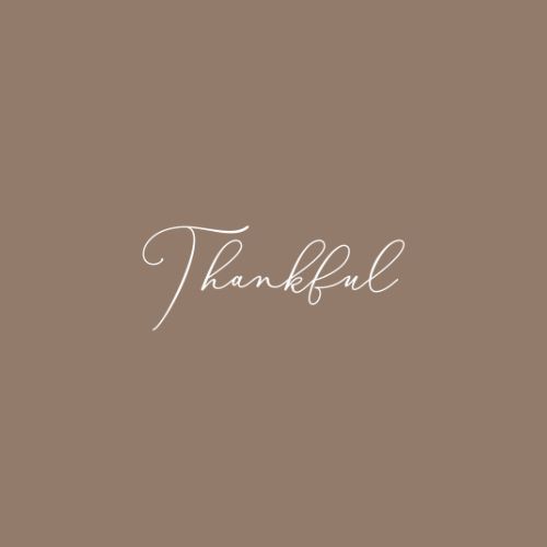 the word thank written in white ink on a brown background