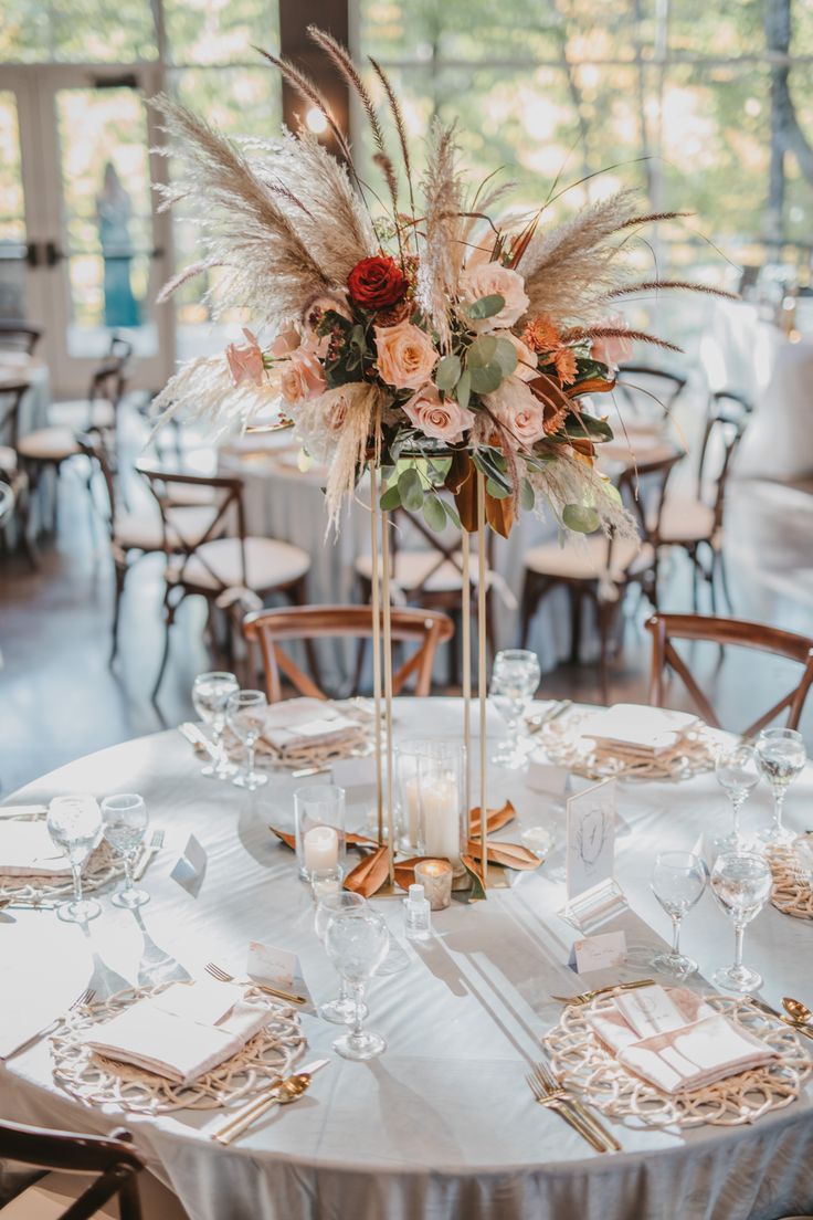 an elegant centerpiece is displayed on a round table