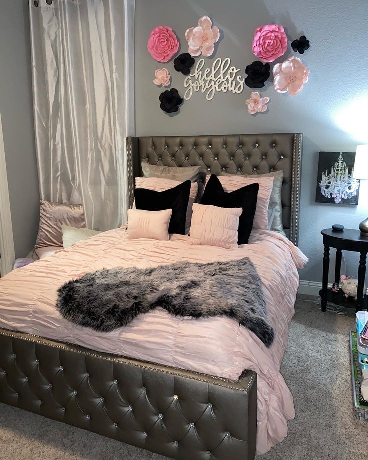 a bed with pink and black decor in a bedroom