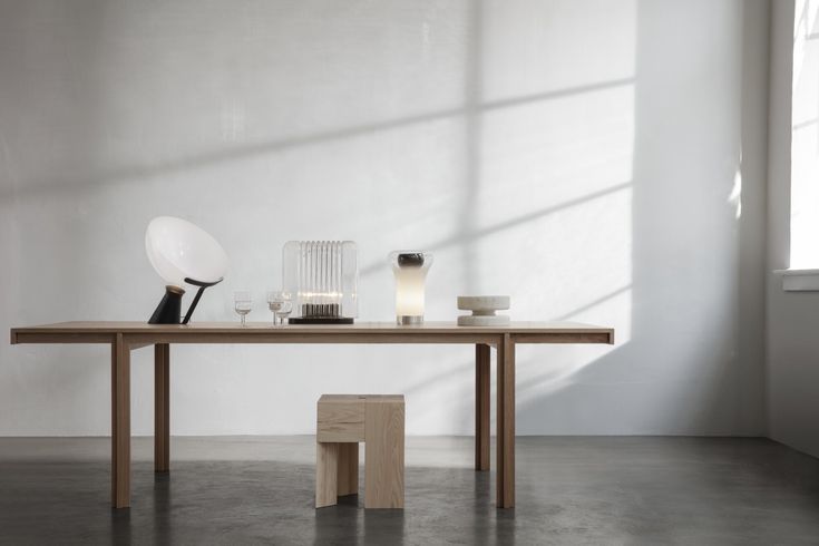 a wooden table with two vases on it