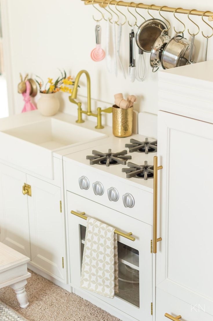 a white stove top oven sitting inside of a kitchen