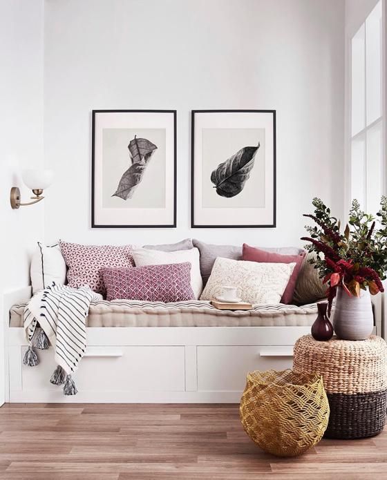 a living room filled with furniture and pictures on the wall