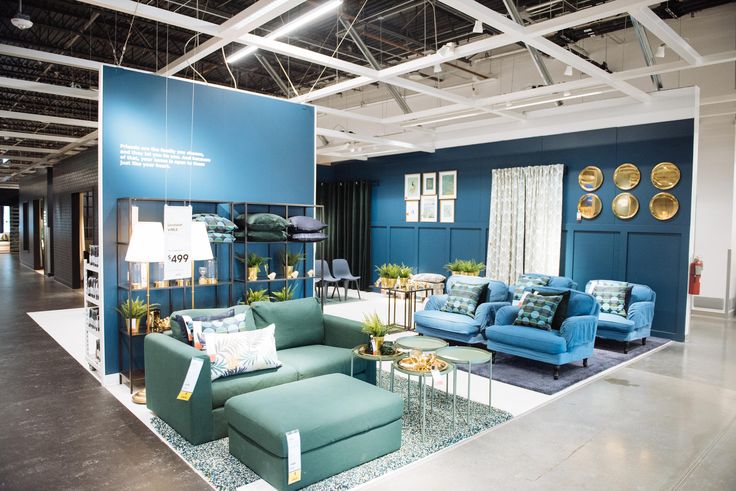 a room filled with lots of furniture and walls covered in blue wall coverings,