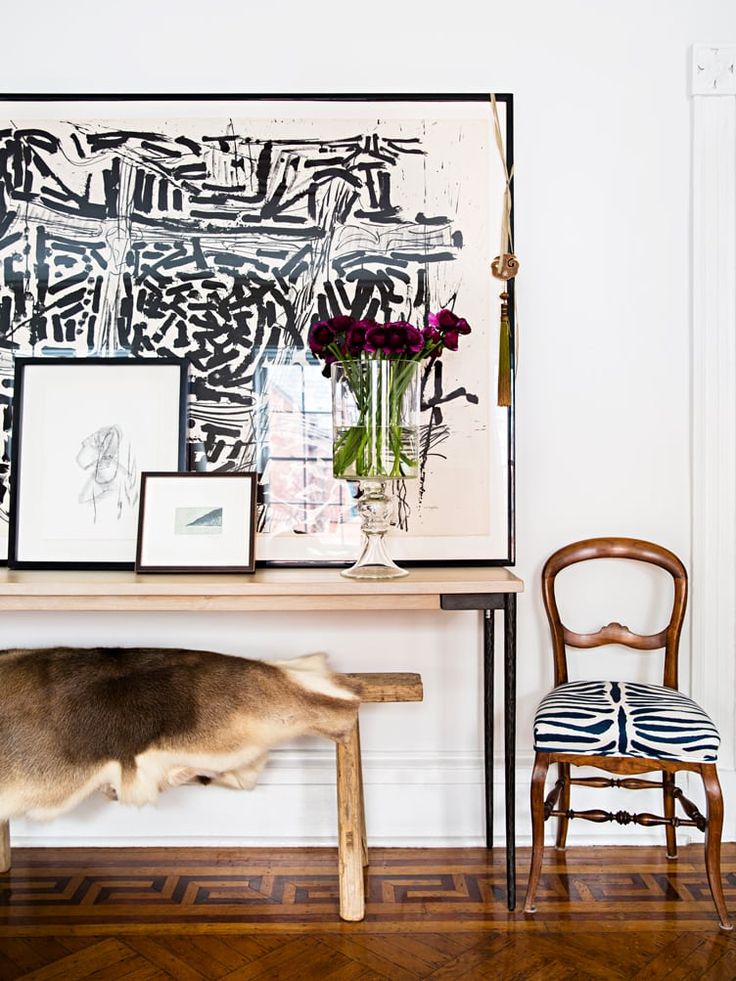 an image of a table with pictures on it and a chair in front of it