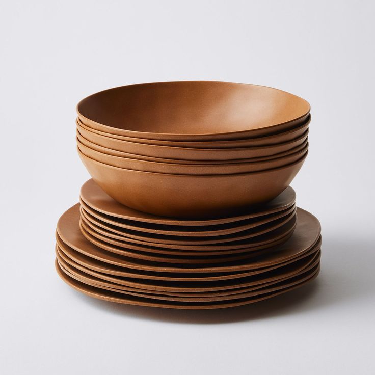 a stack of brown plates sitting on top of each other