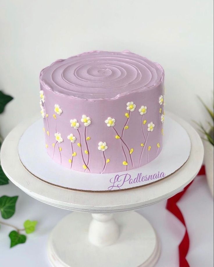 a pink cake with white flowers on it