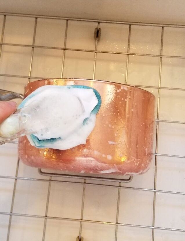 someone is using a spoon to dip something into a container