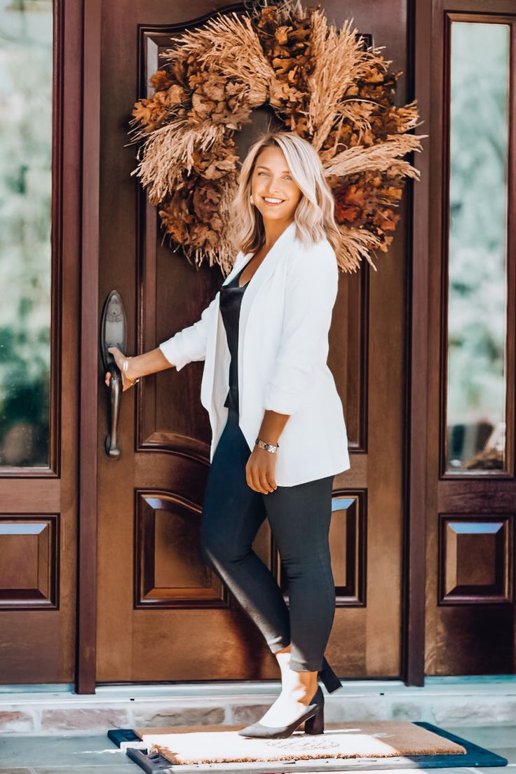 a woman standing in front of a door