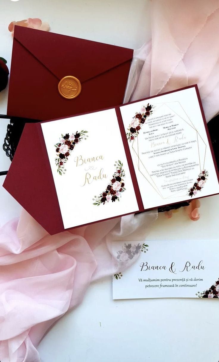 the wedding stationery is laid out on top of each other, including an envelope