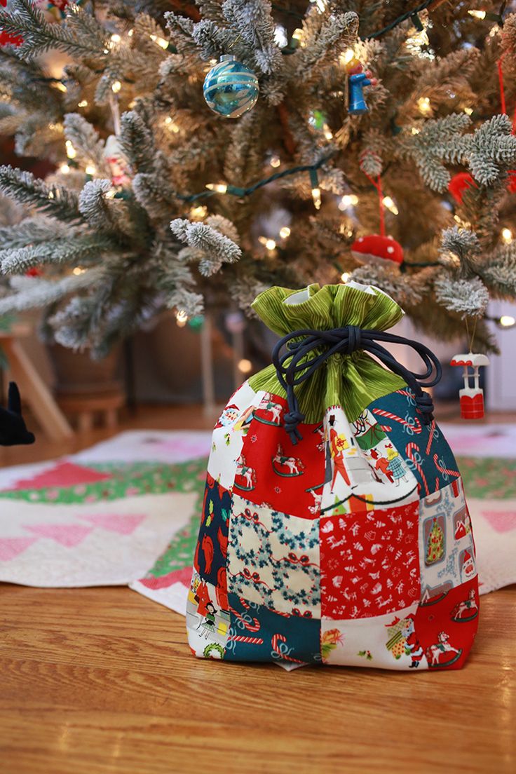 a bag sitting on the floor next to a christmas tree