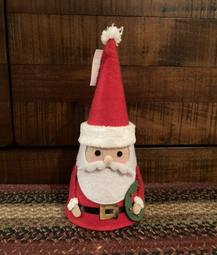 a red and white santa clause hat sitting on top of a rug