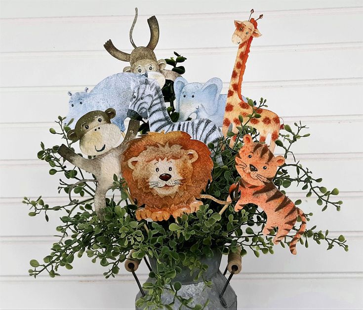 a vase filled with stuffed animals and greenery