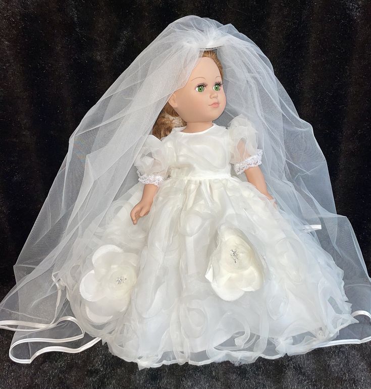 a doll dressed in a white dress and veil