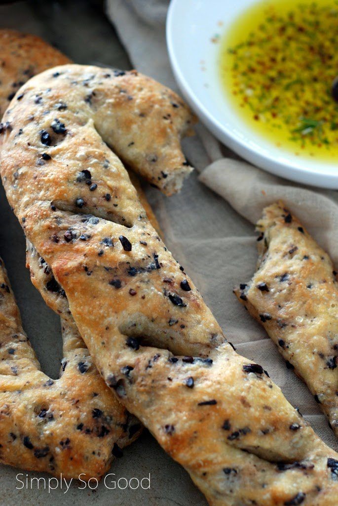 bread sticks with olives and oil on the side