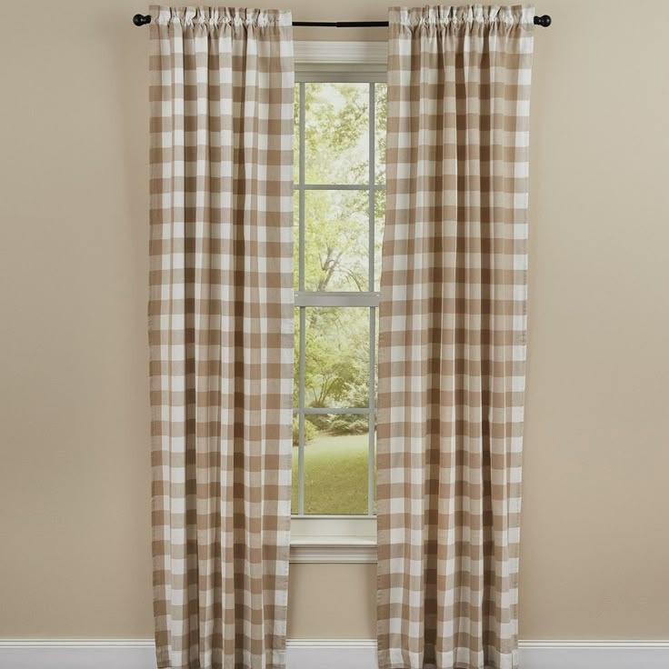 a window with a checkered curtain hanging from it's side